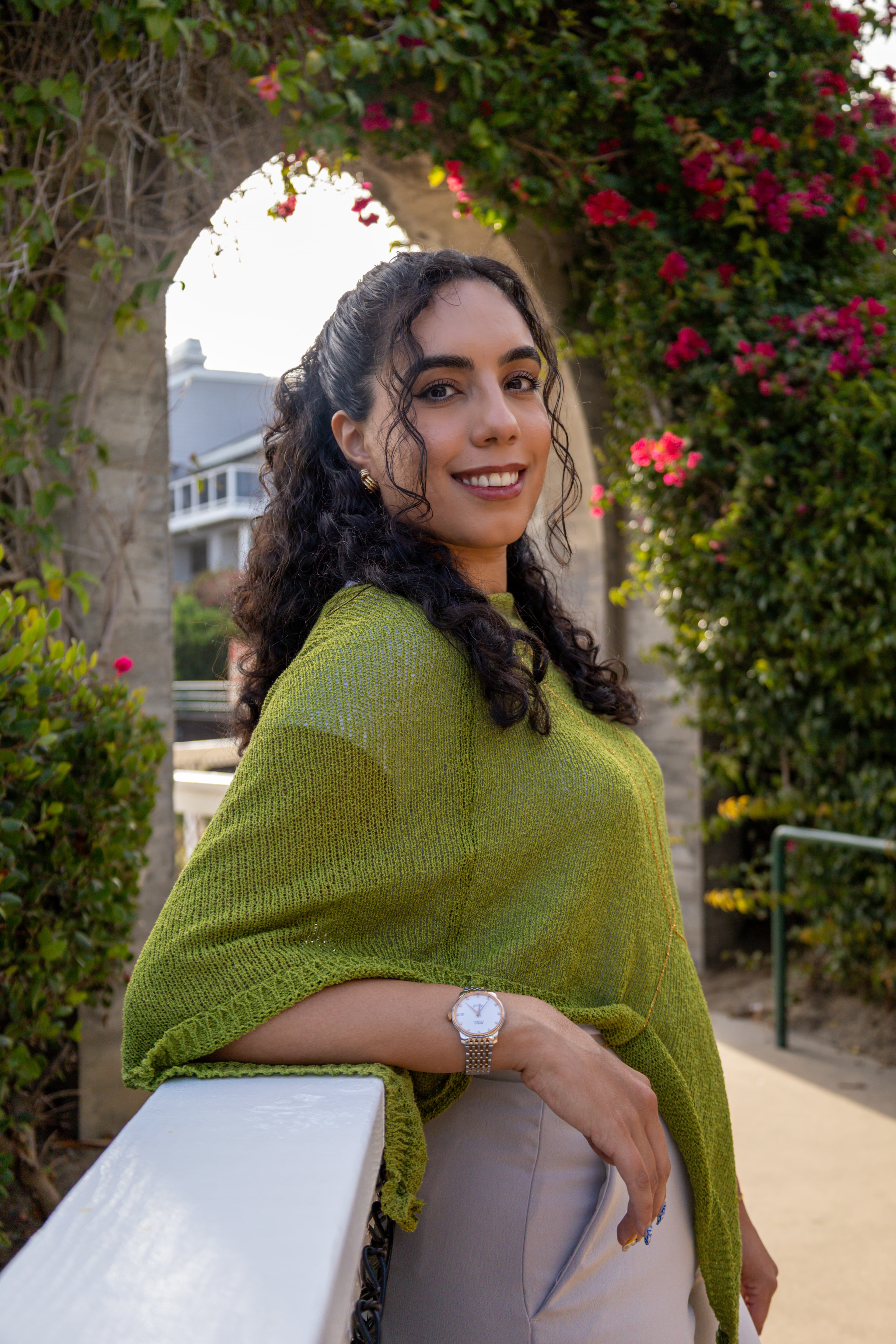 Portrait photographed by ShuhraBilNoor, client smiling over her shoulder under a flowering archway